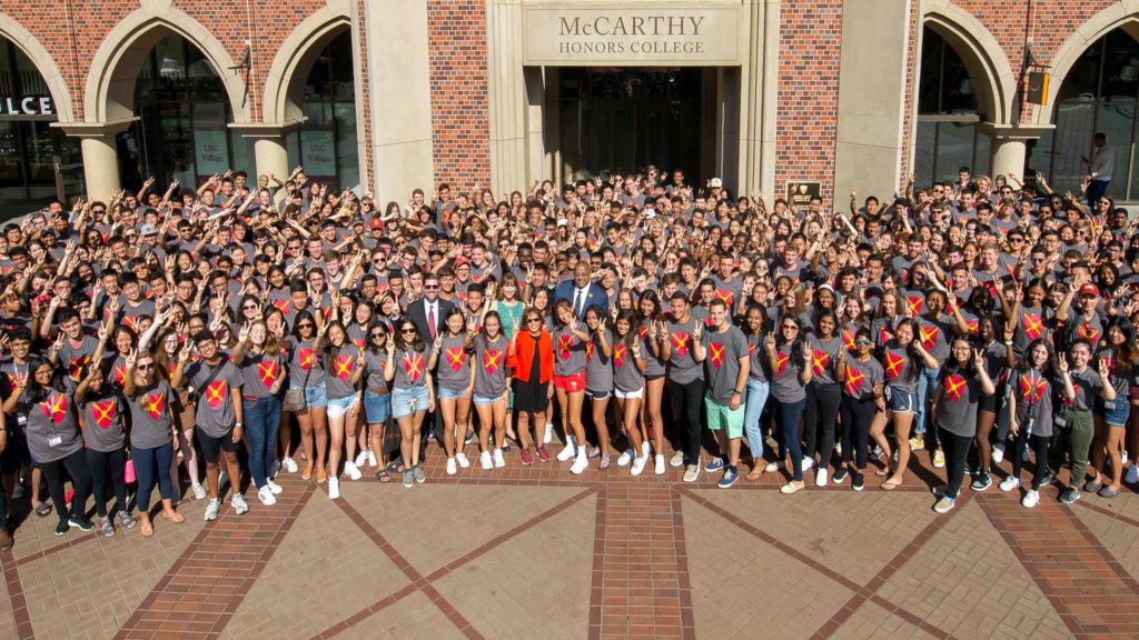 President Carol L. Folt with students at the USC Village